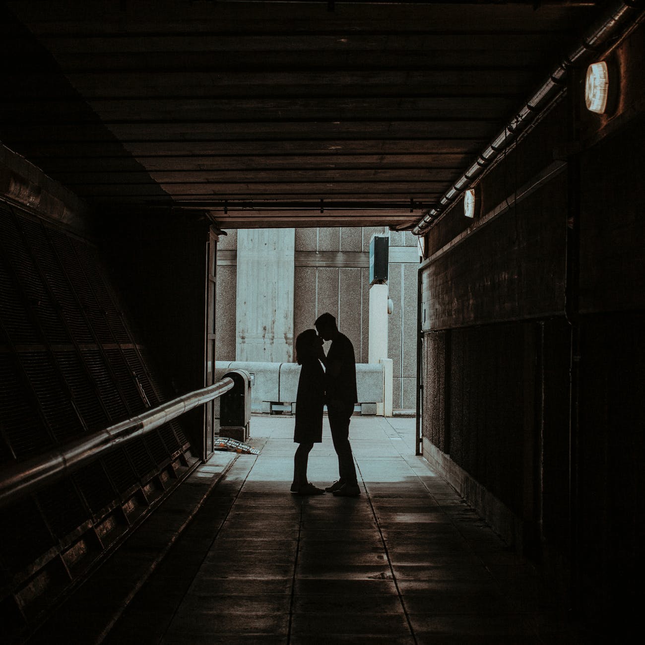 photo of couple kissing in hallway