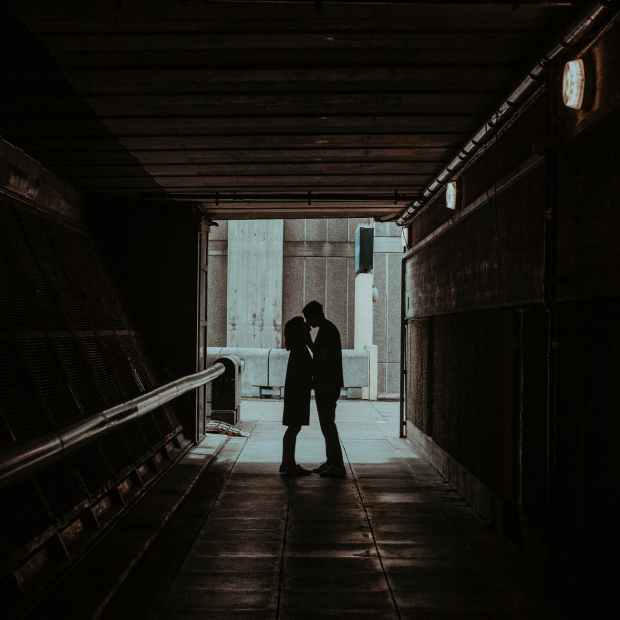 photo of couple kissing in hallway