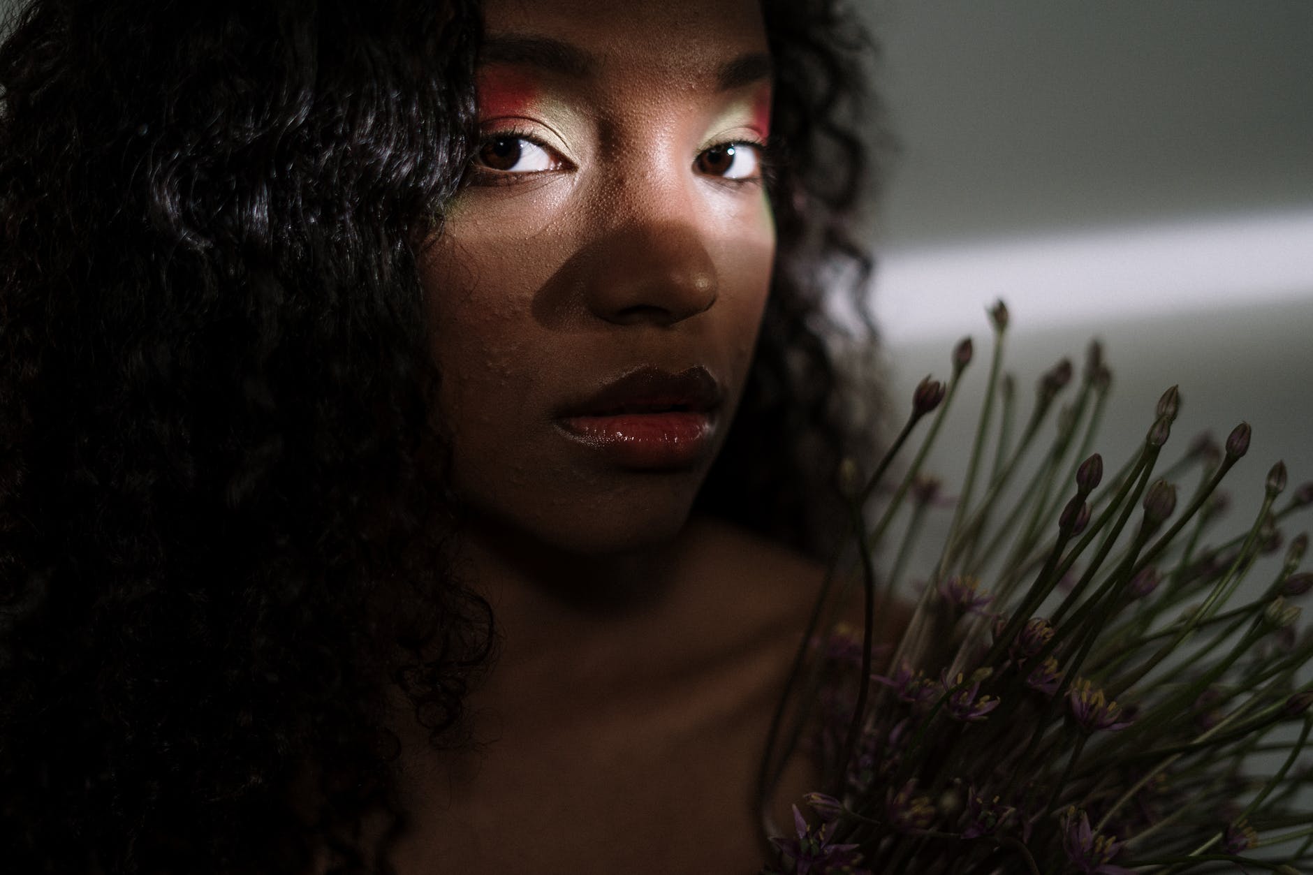 woman in red lipstick near green plant