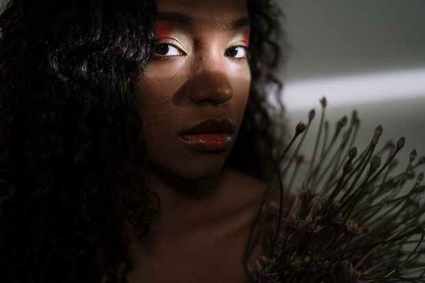 woman in red lipstick near green plant